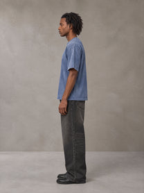 Model wearing the SM Monkey Washed T-shirt in Chambray, side profile.