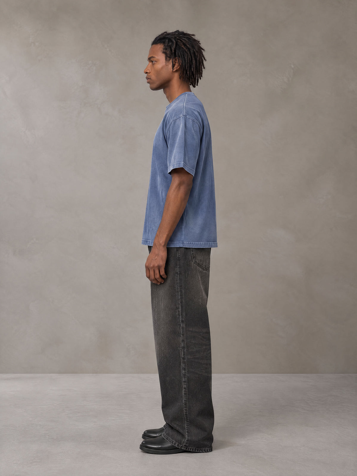 Model wearing the SM Monkey Washed T-shirt in Chambray, side profile.