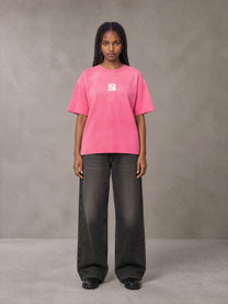 Model wearing the SM Monkey Washed T-shirt in Vivid Pink, front view.