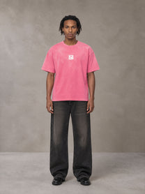 Model wearing the SM Monkey Washed T-shirt in Vivid Pink, front view.