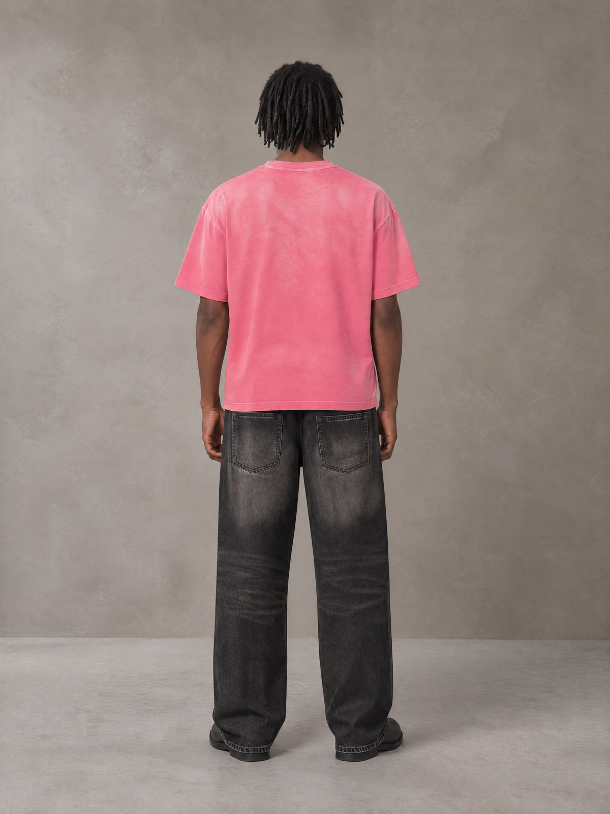 Model wearing the SM Monkey Washed T-shirt in Vivid Pink, rear view.
