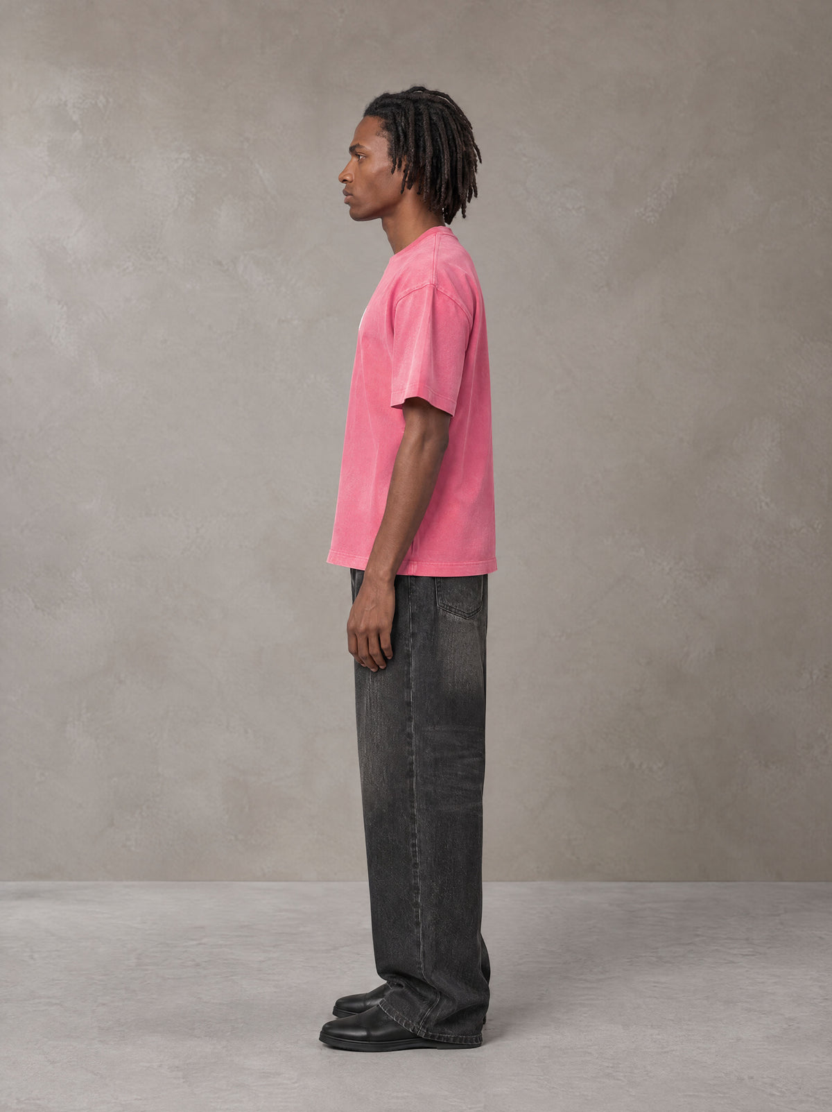 Model wearing the SM Monkey Washed T-shirt in Vivid Pink, side profile.