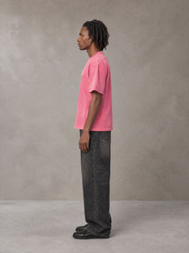 Model wearing the SM Monkey Washed T-shirt in Vivid Pink, side profile.