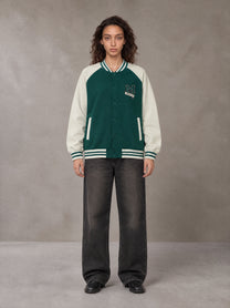 Model wearing the SM Varsity Jacket in Alpine Green, front view.