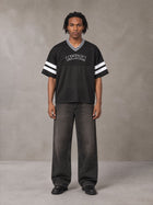 Model wearing the SM Varsity Spirit T-shirt in Midnight Black, front view.