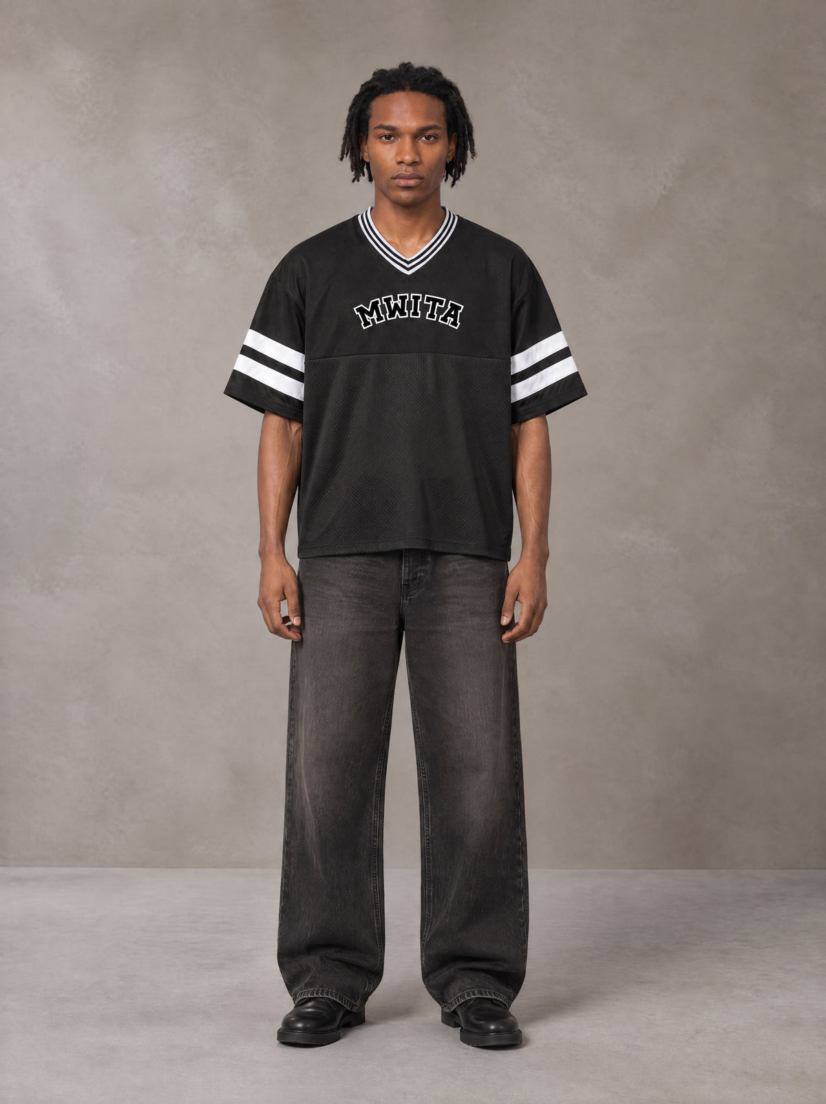 Model wearing the SM Varsity Spirit T-shirt in Midnight Black, front view.