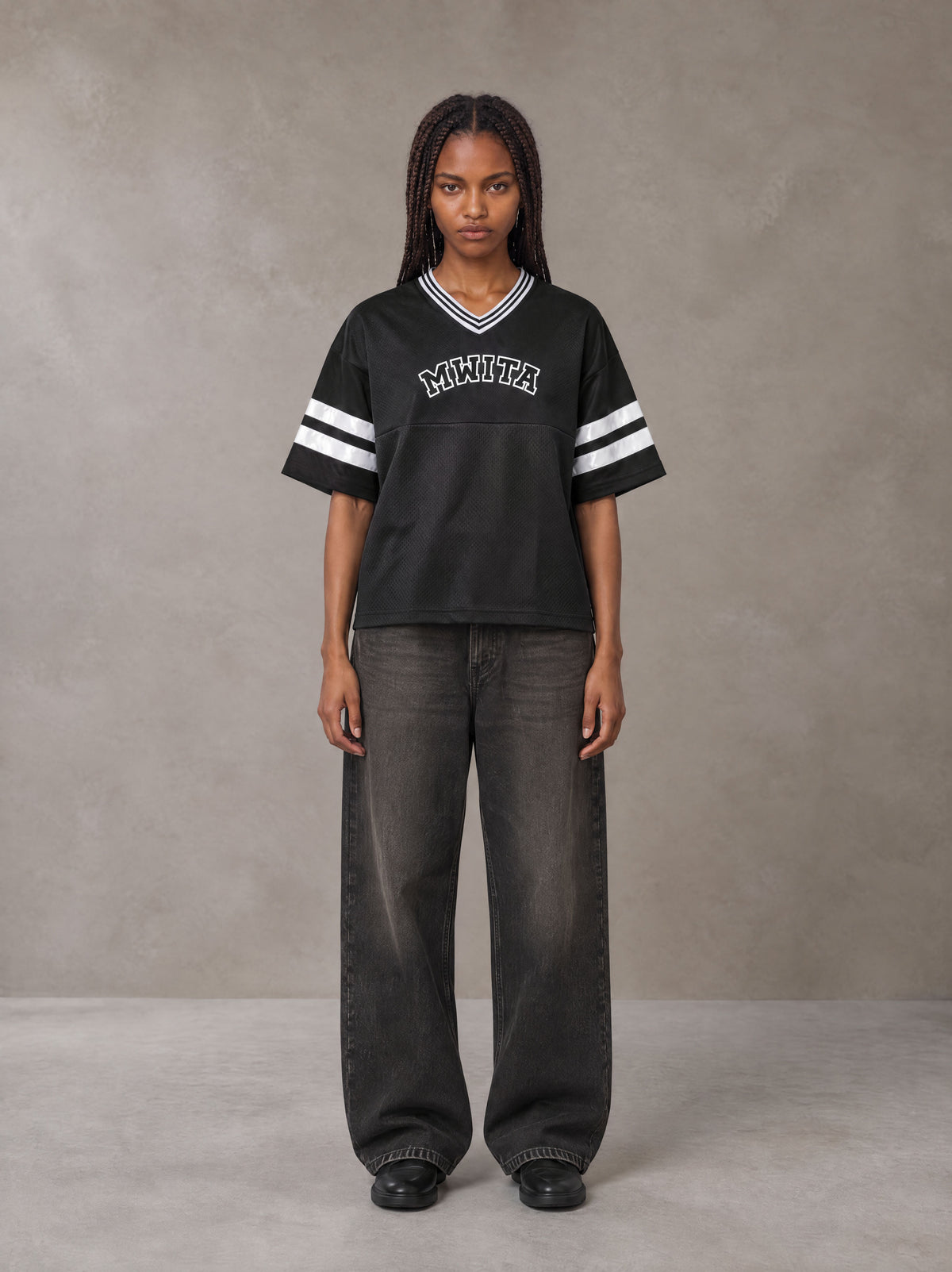 Model wearing the SM Varsity Spirit T-shirt in Midnight Black, front view.