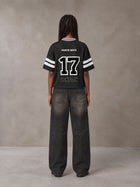 Model wearing the SM Varsity Spirit T-shirt in Midnight Black, rear view.
