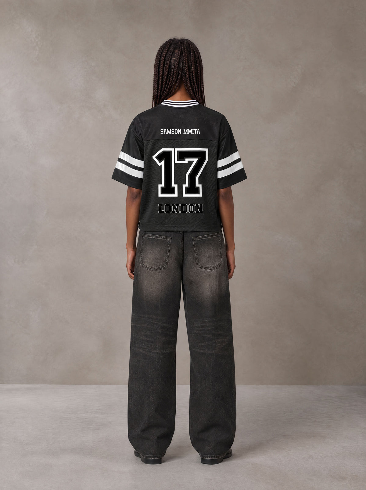 Model wearing the SM Varsity Spirit T-shirt in Midnight Black, rear view.