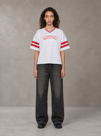Model wearing the SM Varsity Spirit T-shirt in Lucent White, front view.