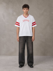 Model wearing the SM Varsity Spirit T-shirt in Lucent White, front view.