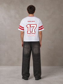 Model wearing the SM Varsity Spirit T-shirt in Lucent White, rear view.