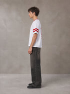 Model wearing the SM Varsity Spirit T-shirt in Lucent White, side profile.