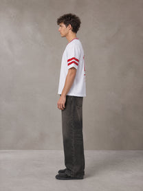 Model wearing the SM Varsity Spirit T-shirt in Lucent White, side profile.