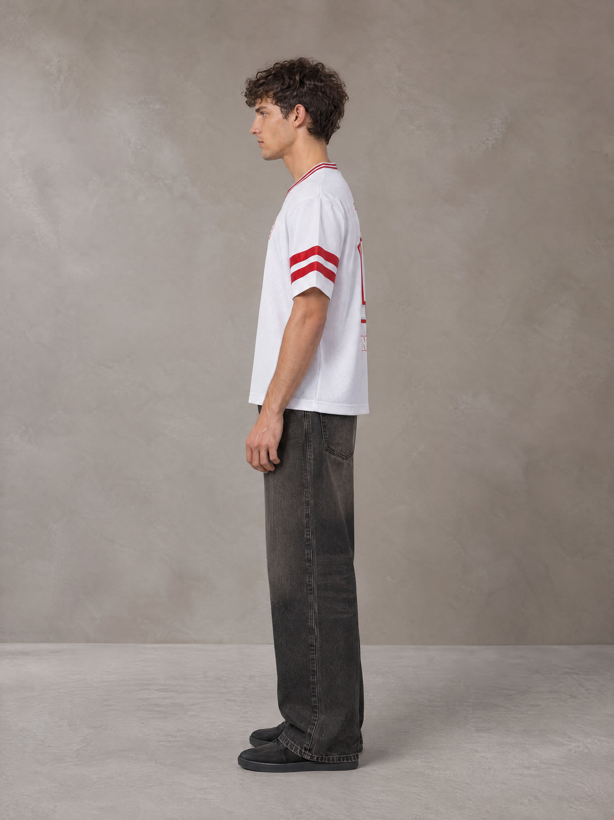 Model wearing the SM Varsity Spirit T-shirt in Lucent White, side profile.