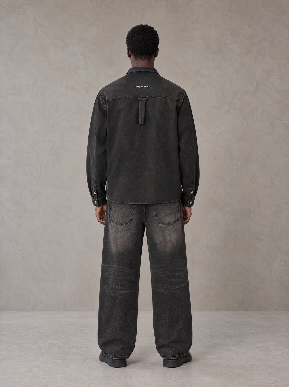 Model wearing the SM Washed Atelier Overshirt in Midnight Black, rear view.