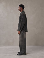 Model wearing the SM Washed Atelier Overshirt in Midnight Black, side profile.
