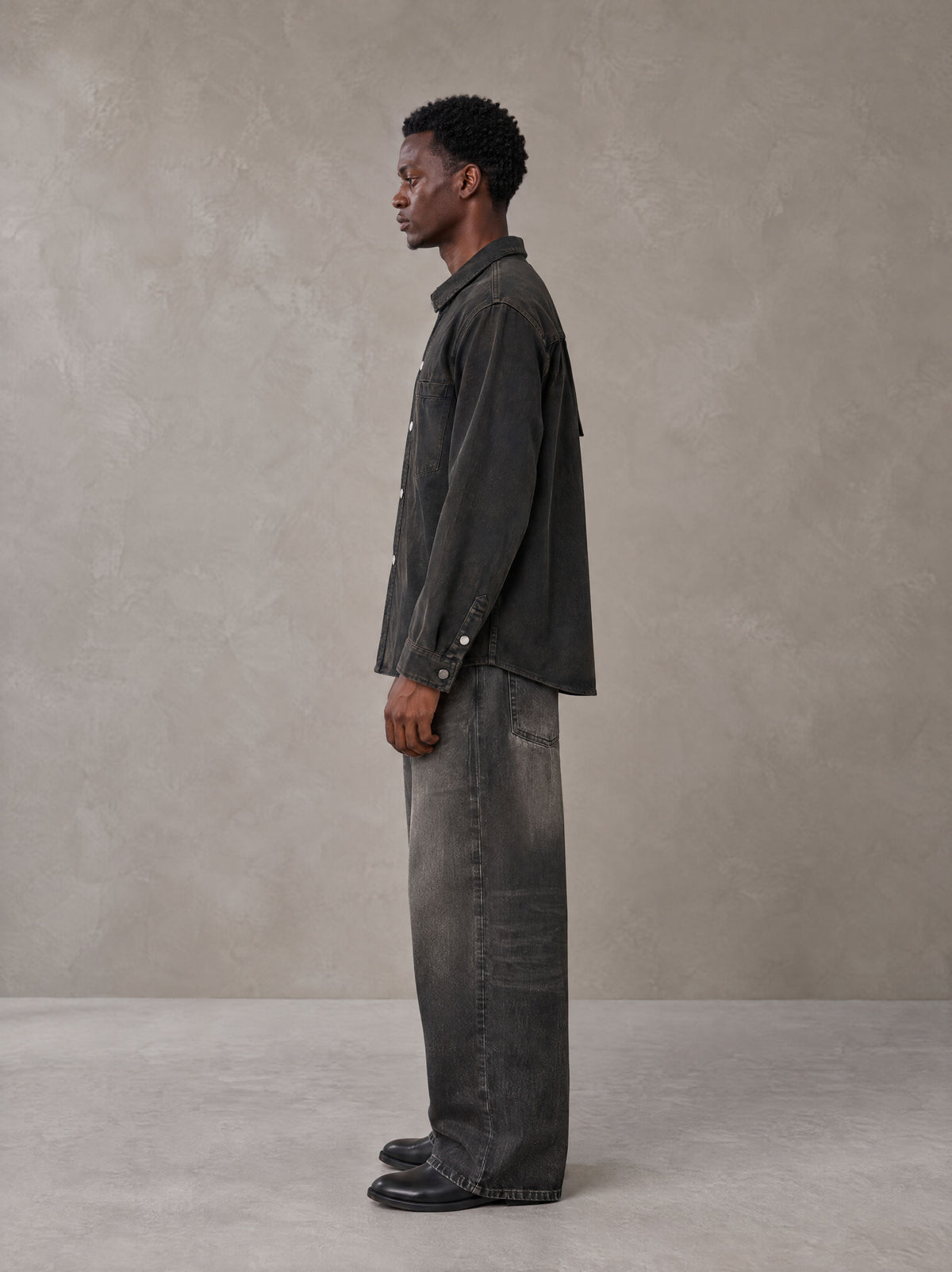 Model wearing the SM Washed Atelier Overshirt in Midnight Black, side profile.