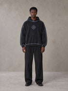 Model wearing the SM Pleated Trousers in Midnight Black, front view.