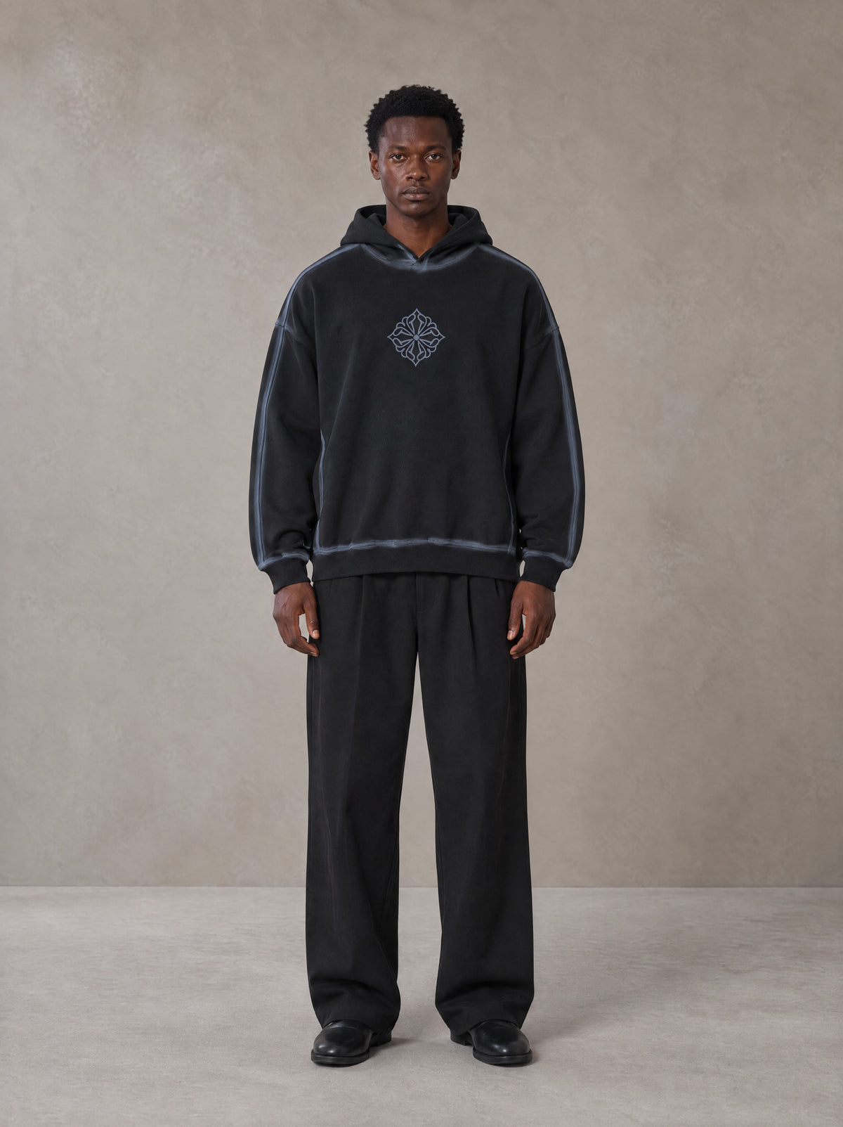 Model wearing the SM Pleated Trousers in Midnight Black, front view.