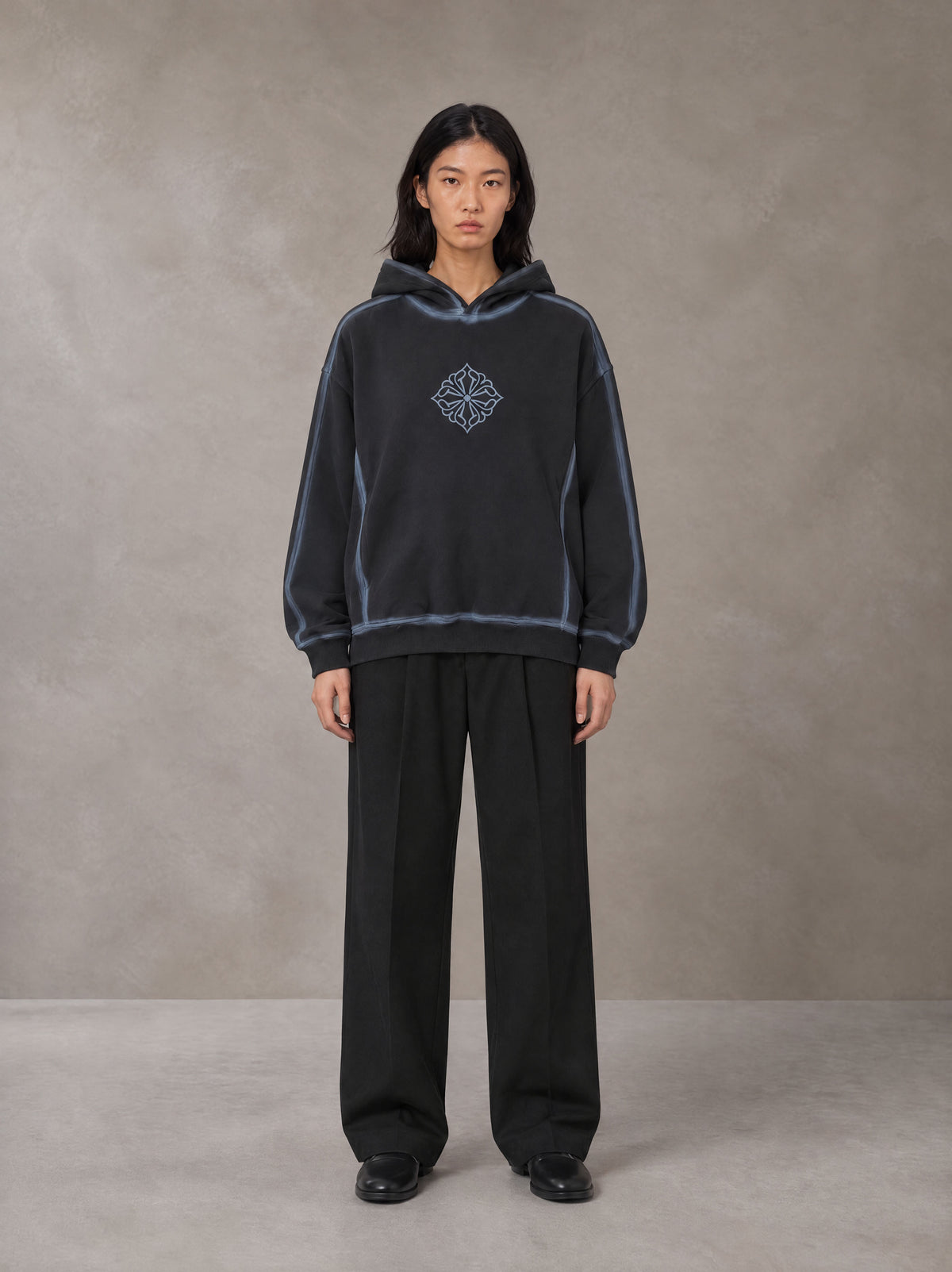 Model wearing the SM Pleated Trousers in Midnight Black, front view.