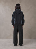 Model wearing the SM Pleated Trousers in Midnight Black, rear view.