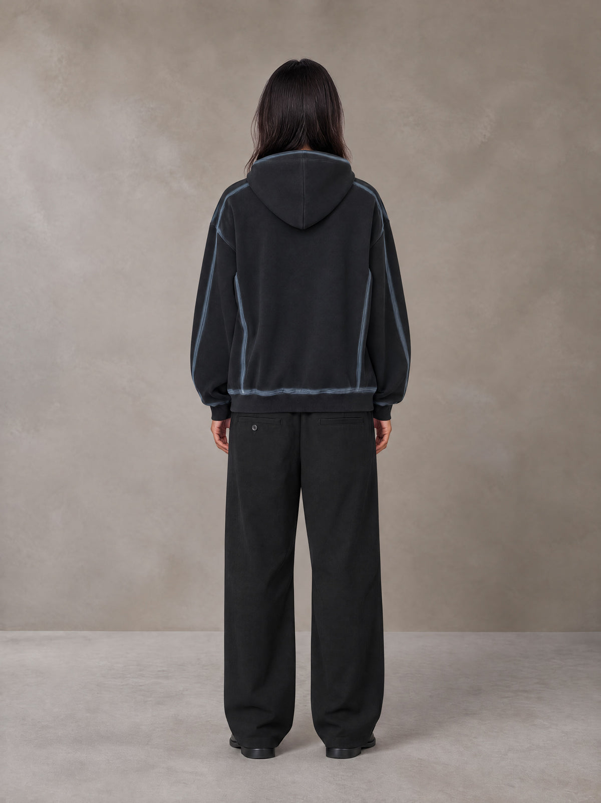 Model wearing the SM Pleated Trousers in Midnight Black, rear view.