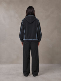 Model wearing the SM Pleated Trousers in Midnight Black, rear view.