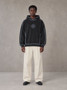 Model wearing the SM Pleated Trousers in Soft Beige, front view.