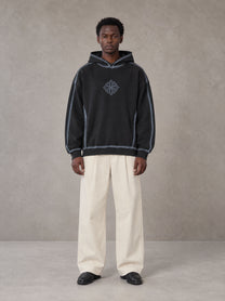 Model wearing the SM Pleated Trousers in Soft Beige, front view.