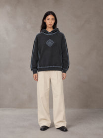 Model wearing the SM Pleated Trousers in Soft Beige, front view.