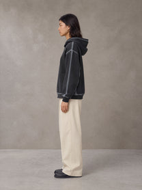Model wearing the SM Pleated Trousers in Soft Beige, side profile.