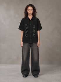 Model wearing the SM Shadow Pulse Shirt in Midnight Black, front view.