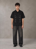 Model wearing the SM Shadow Pulse Shirt in Midnight Black, front view.