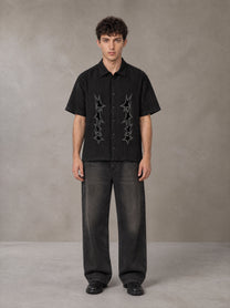 Model wearing the SM Shadow Pulse Shirt in Midnight Black, front view.