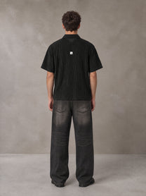 Model wearing the SM Shadow Pulse Shirt in Midnight Black, rear view.