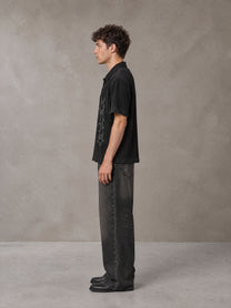 Model wearing the SM Shadow Pulse Shirt in Midnight Black, side profile.