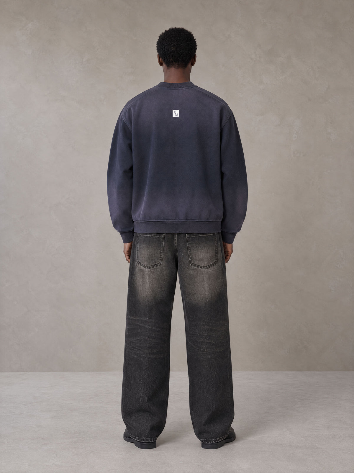 Model wearing the SM Sig. Shadow Fade Bomber Jacket in Deep Purple, rear view.