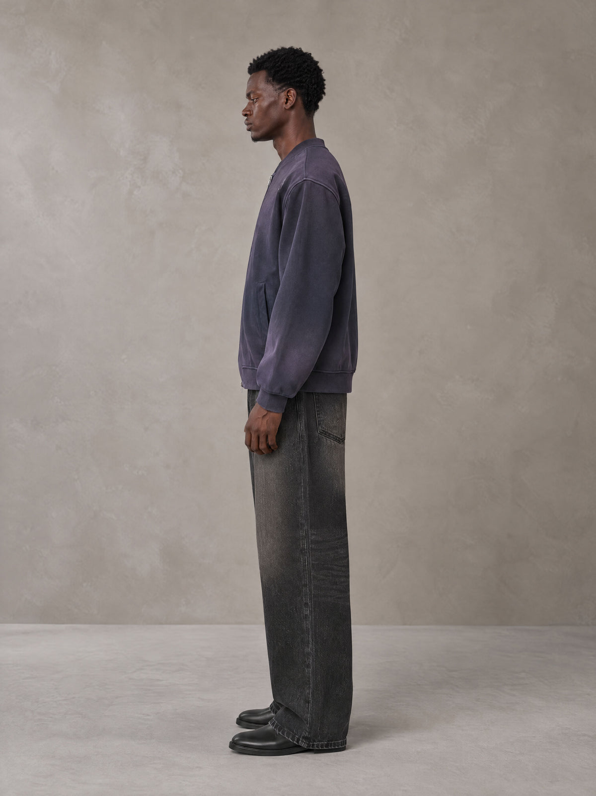 Model wearing the SM Sig. Shadow Fade Bomber Jacket in Deep Purple, side profile.