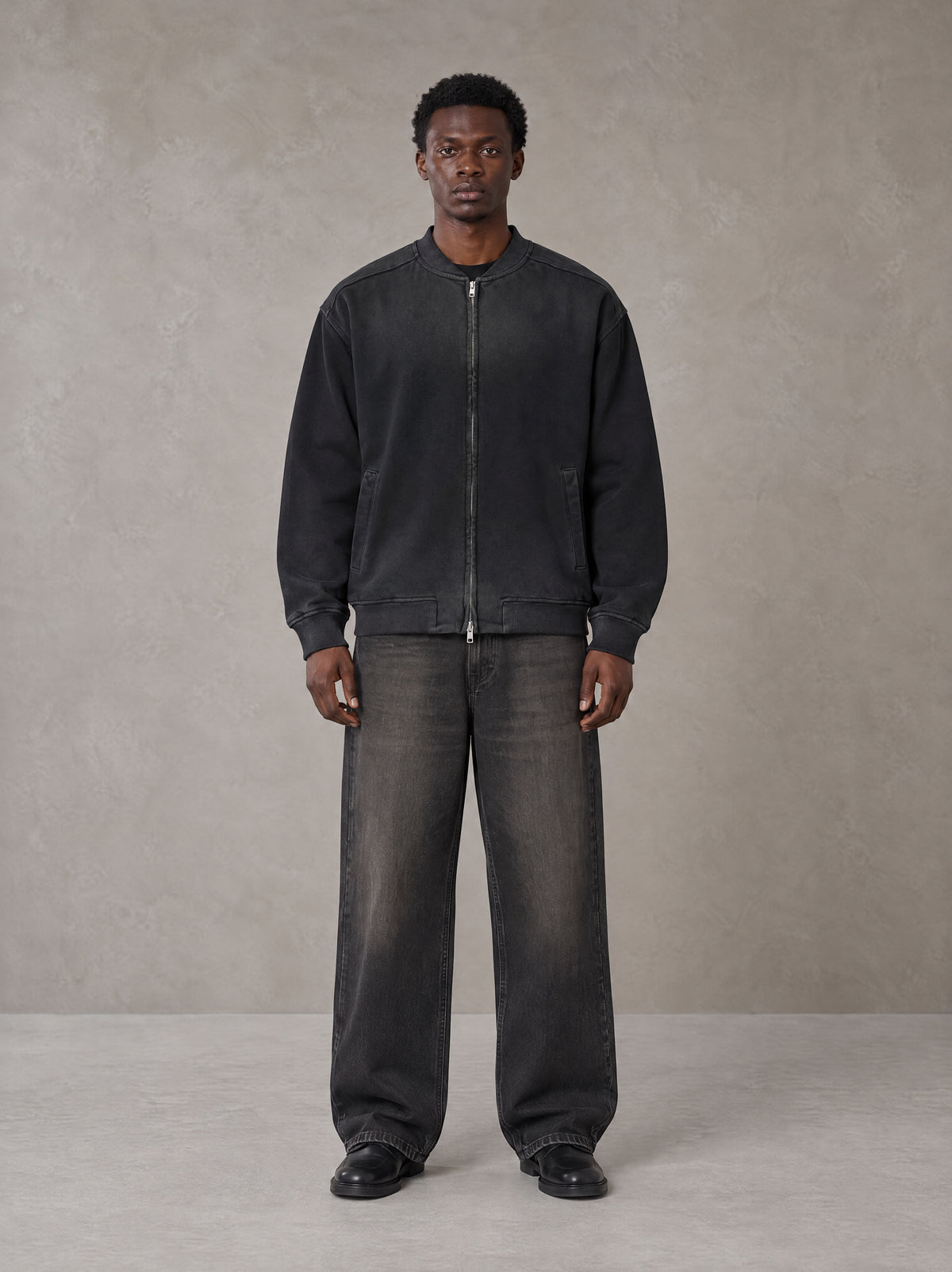 Model wearing the SM Sig. Shadow Fade Bomber Jacket in Midnight Black, front view.