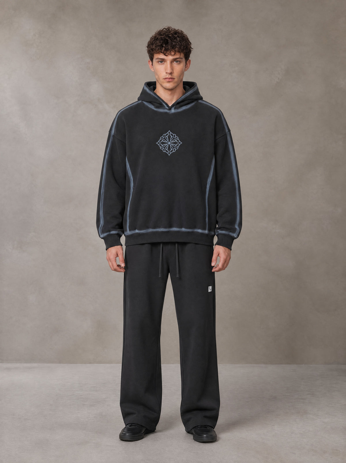 Model wearing the SM Sig. Straight Leg Sweatpants in Deep Charcoal, front view.