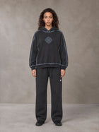 Model wearing the SM Sig. Straight Leg Sweatpants in Deep Charcoal, front view.