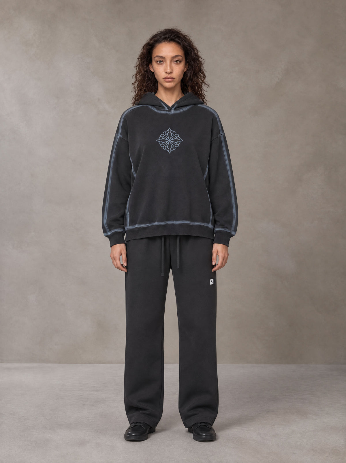 Model wearing the SM Sig. Straight Leg Sweatpants in Deep Charcoal, front view.