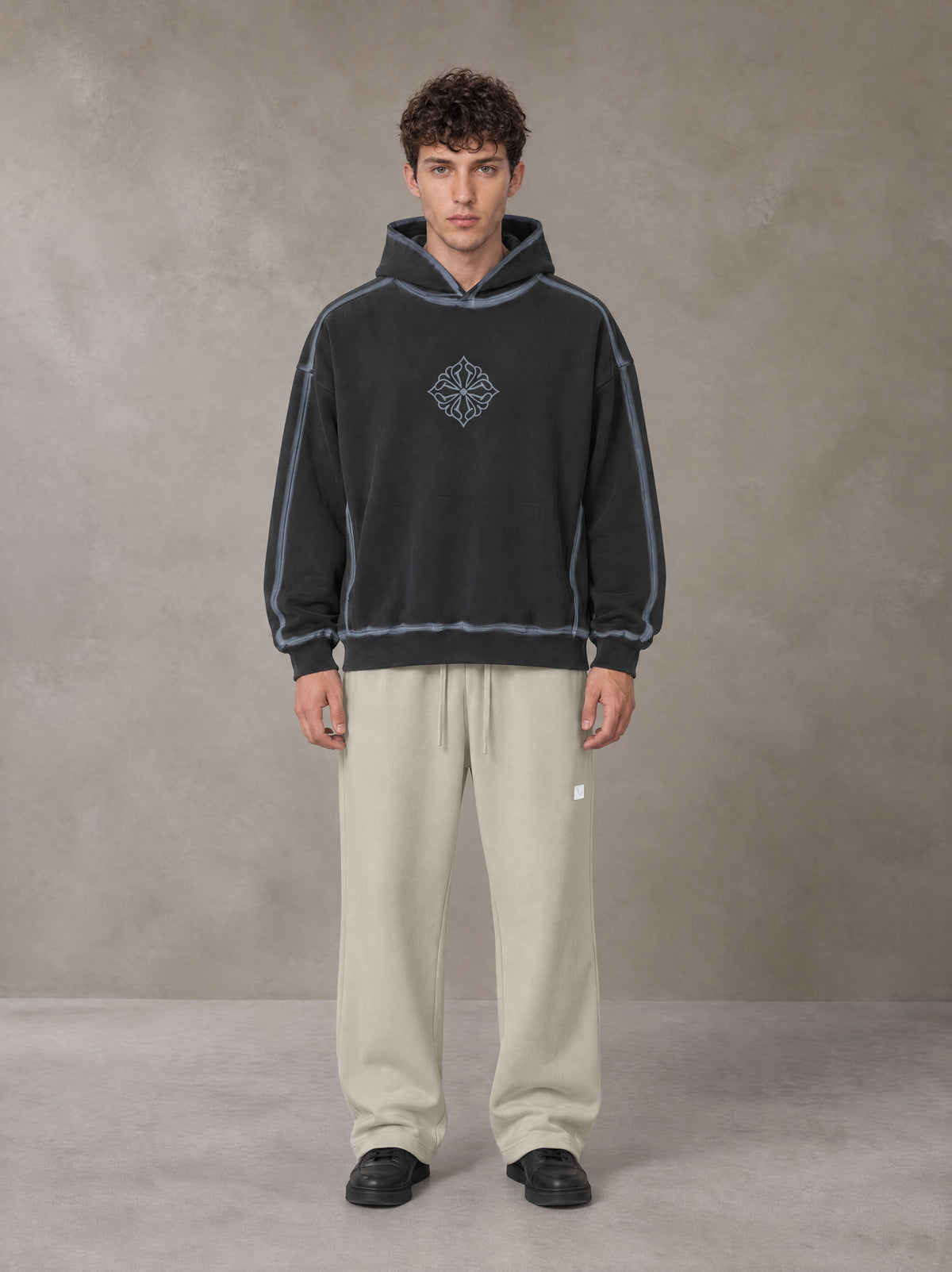 Model wearing the SM Sig. Straight Leg Sweatpants in Fine Sand, front view.