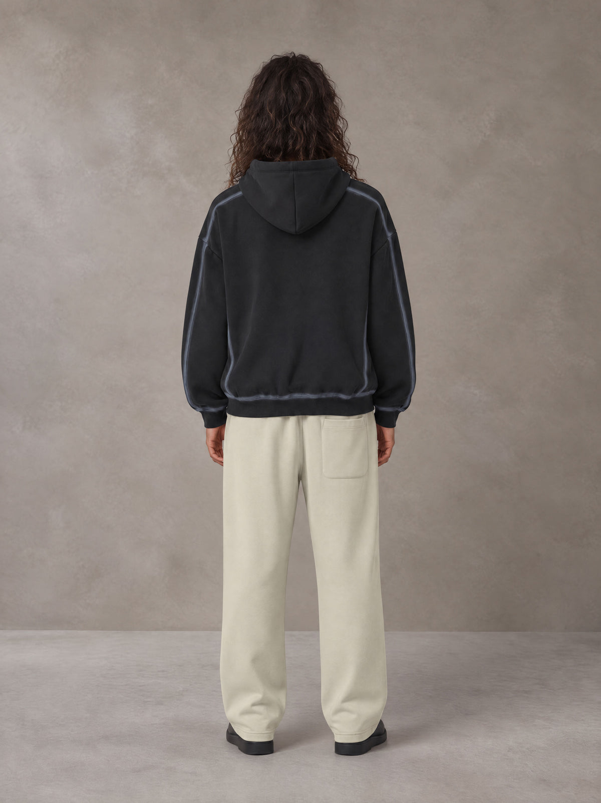Model wearing the SM Sig. Straight Leg Sweatpants in Fine Sand, rear view.