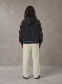 Model wearing the SM Sig. Straight Leg Sweatpants in Fine Sand, rear view.