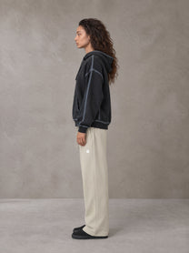Model wearing the SM Sig. Straight Leg Sweatpants in Fine Sand, side profile.