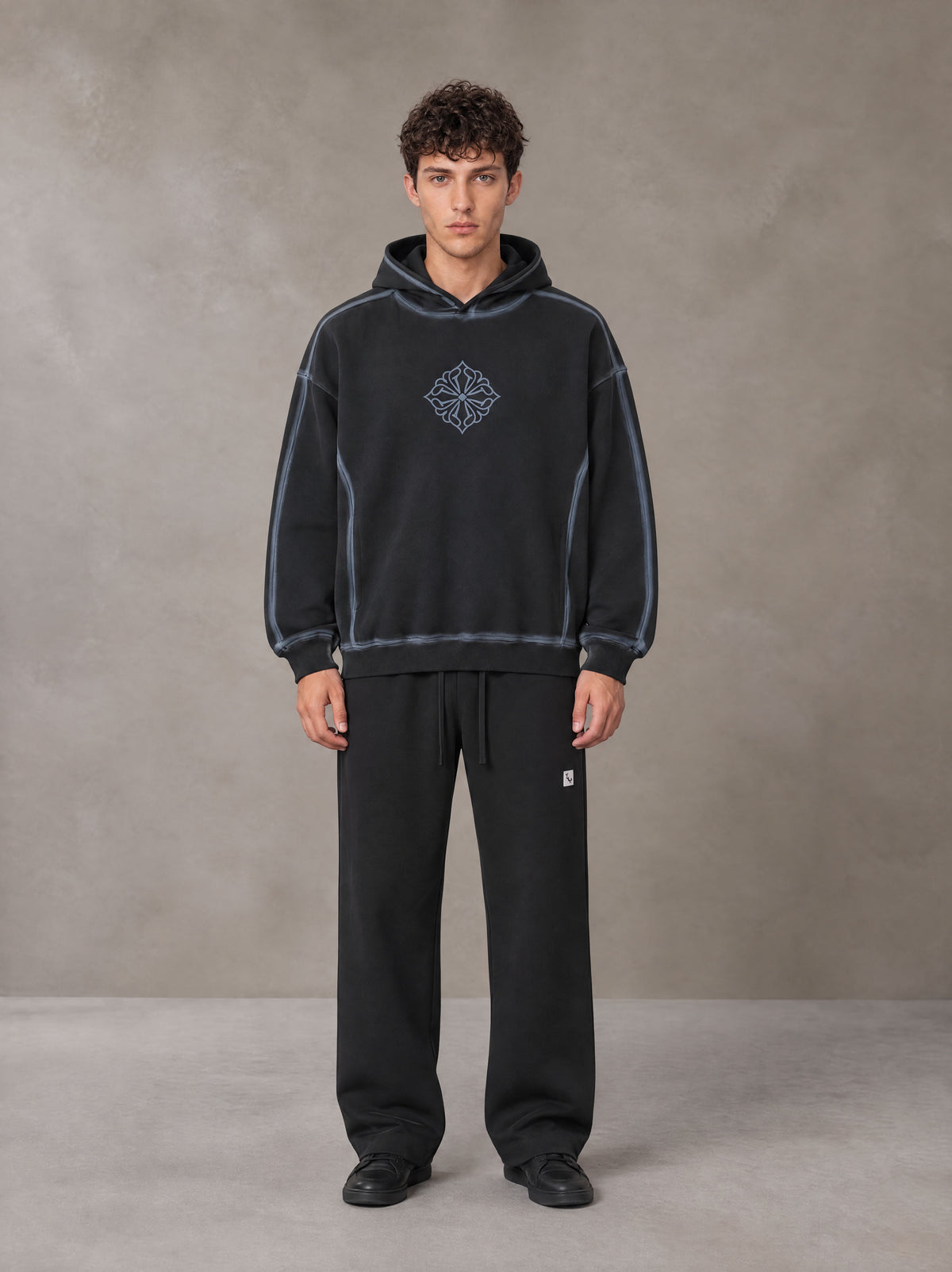 Model wearing the SM Sig. Straight Leg Sweatpants in Midnight Black, front view.