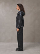 Model wearing the SM Sig. Straight Leg Sweatpants in Midnight Black, side profile.