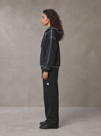 Model wearing the SM Sig. Straight Leg Sweatpants in Midnight Black, side profile.